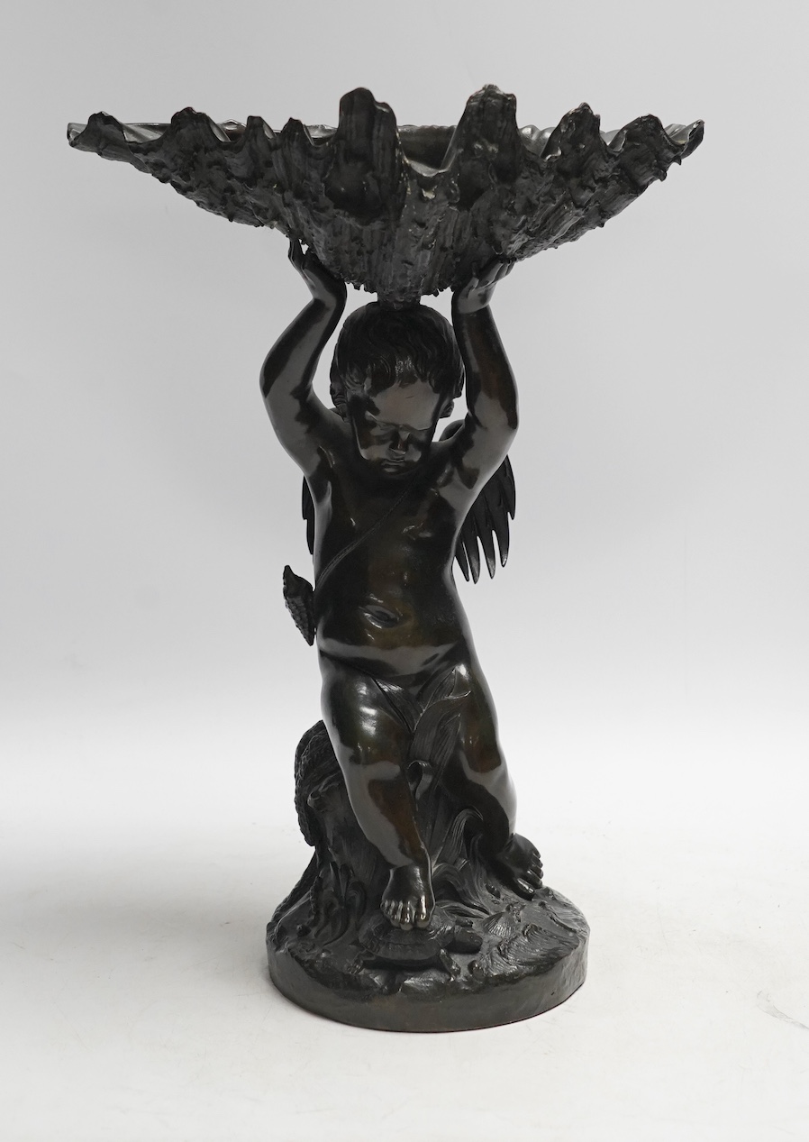 A 19th century bronze figure or centrepiece in the form of putti holding a shell, 34cm